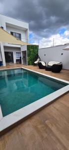 a swimming pool in front of a house at Espaço prime piscina aquecida in Sorocaba