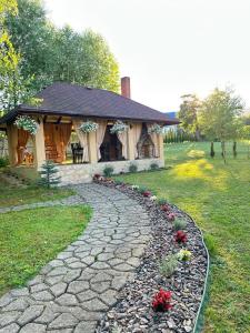 a stone path leading to a house with a building at Садиба Villa Bella in Velyatyn