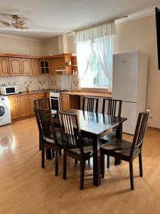 a kitchen with a dining room table and chairs at Садиба Villa Bella in Velyatyn