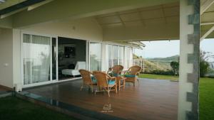 a patio with chairs and a table on a house at The Upper Deck in Pīrmed