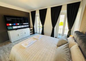 a bedroom with a large bed and a television at Villa Felix in Omegna