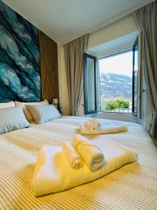 a hotel room with two beds with towels on them at Villa Felix in Omegna