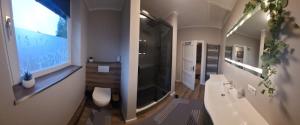 a bathroom with a tub and a toilet and a sink at Parva Domus XL in Xanten