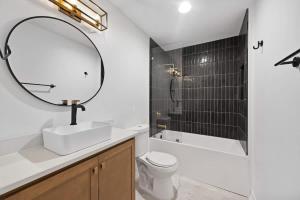 a bathroom with a sink and a mirror and a shower at Park Hotel 1BR Suite 210 in Chattanooga
