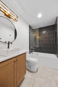 a bathroom with a sink and a toilet and a mirror at Park Hotel 1BR Suite 210 in Chattanooga