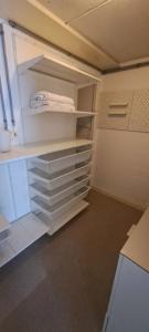 an empty closet with white shelves in a room at Exclusive Loft in Seefeld - Mühle in Zurich +4 photos