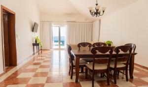 a dining room with a table and chairs at Hotel Checkin El Cortecito Beach in Punta Cana