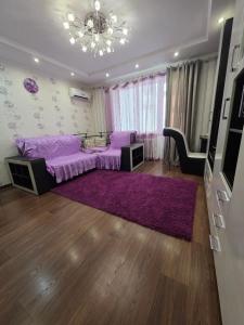 a bedroom with a purple bed and a purple rug at Квартира in Bilhorod-Dnistrovskyi