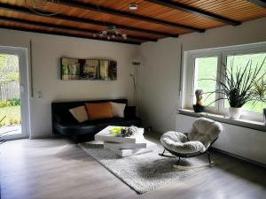 a living room with a couch and a chair at Ferienwohnung Im Auricher Tal in Vaihingen an der Enz