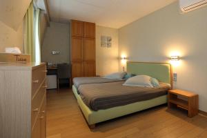 a small bedroom with a bed and a desk at Radici in Nieuwpoort +52 photos