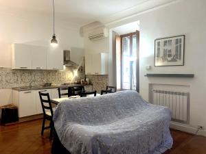a bedroom with a bed and a kitchen with a table at Bilocale zona Testaccio in Rome