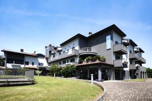 a large building with a lawn in front of it at Hotel Residence Aurora in Paderno Dugnano +100 photos