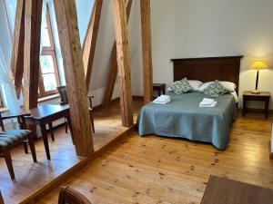 a bedroom with a bed and a table and chairs at Pałac w Rymaniu in Rymań +75 photos