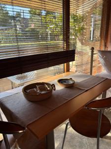 a table with two bowls on it with a window at Studio with garden in Selínia