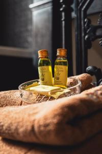 two bottles of oil sitting on top of a table at L'Hotel Particulier in Louhans