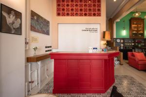 a red island in a room with a red counter at Chinoir Boutique Phuket Town in Phuket