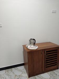 a tea kettle on top of a wooden table at Samiru Guest Inn Ella in Ella