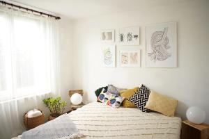 a bedroom with a bed and some pictures on the wall at Villa Old Almond in Balatonalmádi +1 photo