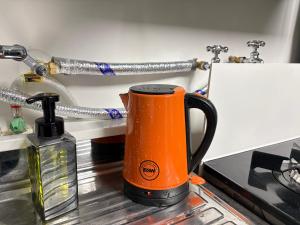 an orange cup sitting on top of a kitchen counter at Stay GaeBong in Seoul