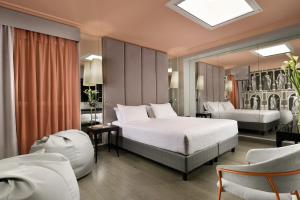 a hotel room with a bed and a mirror at Leon's Place Hotel In Rome in Rome
