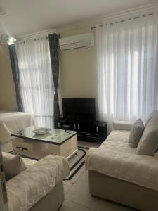 a living room with a bed and a couch at Apartament Oresti in Korçë