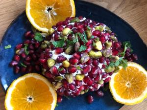 a blue plate of fruit with oranges and nuts at Flusshaus BnB Alicudi in Brugg +5 photos