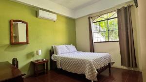 a small bedroom with a bed and a window at Hotel Vizcaíno León in León