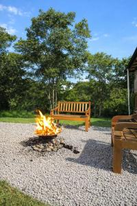 a fire pit with a bench in a park at Hotel Du Rastro in Lauro Müller