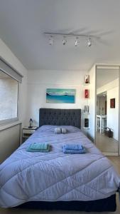 ein Schlafzimmer mit einem großen Bett und zwei Kissen darauf in der Unterkunft RP3 Studio in General Sarmiento