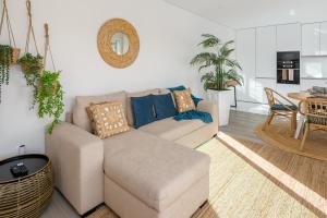a living room with a couch and a table at Aurora do Furadouro II in Ovar
