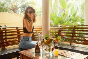 a woman is sitting at a table eating at Lakshmi Ayurveda Retreat in Kovalam