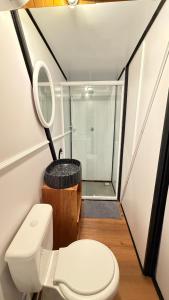 a small bathroom with a toilet and a shower at Cabana no Morro do Macaco in Bombinhas