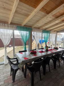 a large table in a room with chairs at Aframe -Melissa in Baia de Fier