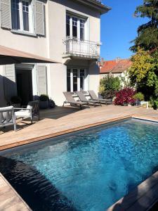 a swimming pool in front of a house at Suite JULIETTE Chambre d'hôte de charme in Mulhouse