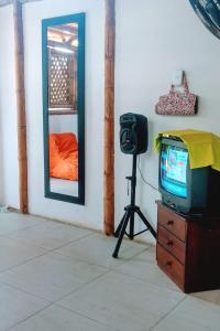 a tv sitting on a dresser next to a mirror at Casa de Guadua in Dibulla +11 photos