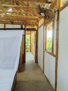 a hallway in a house with a ceiling fan at Casa de Guadua in Dibulla