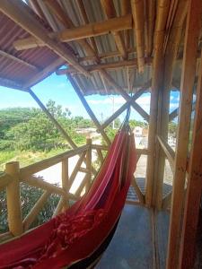 a hammock in a room with a view at Casa de Guadua in Dibulla