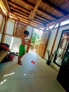 a young boy playing with a ball in a room at Casa de Guadua in Dibulla