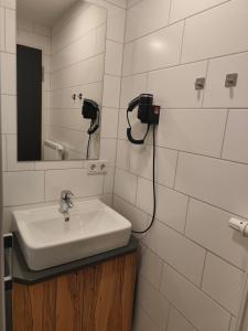 a bathroom with a sink and a mirror on the wall at Gasthof zur Post in Lalling