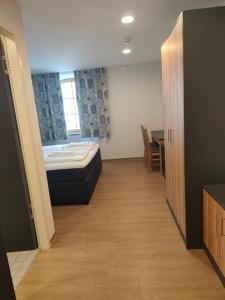 a room with a bed and a table in it at Gasthof zur Post in Lalling