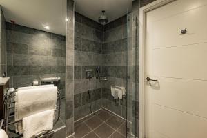 a bathroom with a shower with a glass door at Dakota Eurocentral in Motherwell
