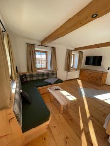 a living room with a couch and a table at Ascherhof in Thiersee