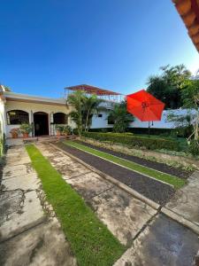 a red umbrella sitting in front of a house at Hotel Vizcaíno León in León