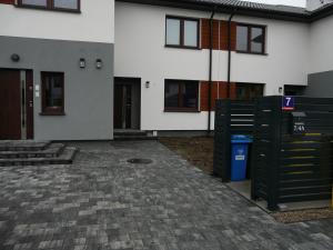 a building with a trash can in front of it at Apartament SezamkowaSKC in Skierniewice
