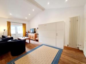 a living room with a couch and a white cabinet at Ferienhaus Hummel in Böhl