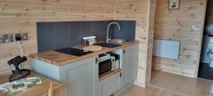 a small kitchen with a sink and a microwave at Stag's View in Ballina