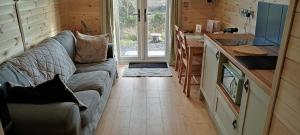 a living room with a couch in a tiny house at Stag's View in Ballina +35 photos