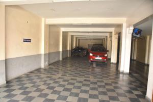 a car is parked in a parking garage at RD Hotel-Near Anna Statue in Perundurai