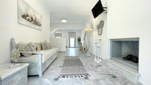 a living room with a couch and a fireplace at DL Santorini in Monolithos