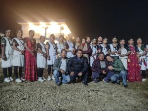 a group of people posing for a picture at night at Hotel Lisne jungle land in Bharatpur